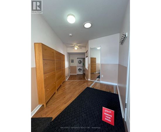 A hallway with a sign that says "Please remove your shoes".