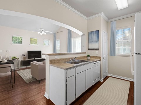 A kitchen with white cabinets and a brown countertop.