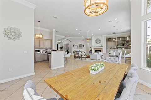 A dining room with a wooden table and chairs.