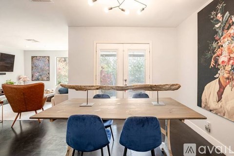 A dining room with a long table and chairs.