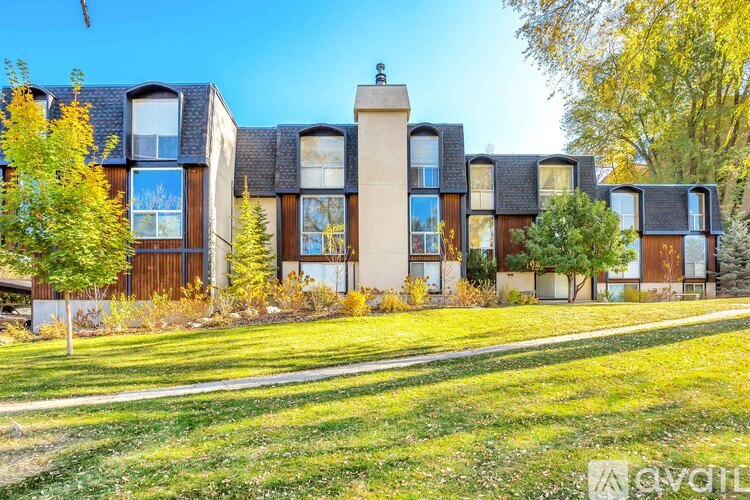 A row of houses with a grassy front yard.
