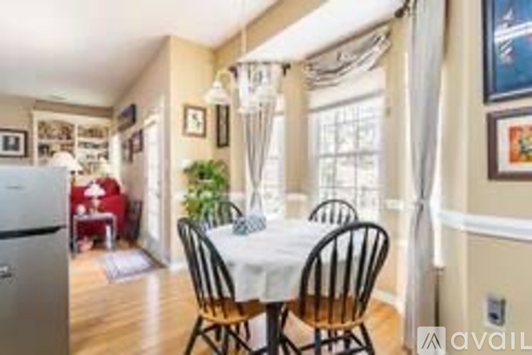 A dining room with a table set for four.