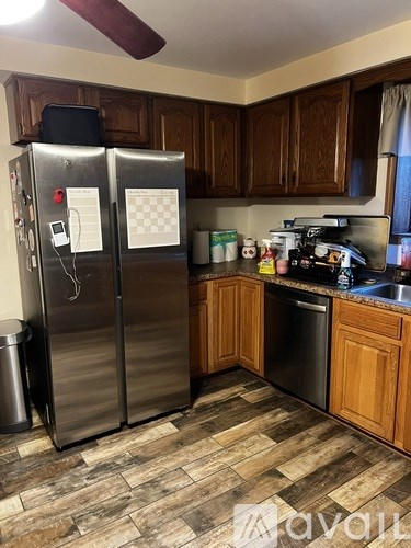 A kitchen with a refrigerator and a dishwasher.