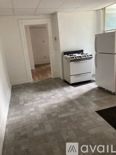 A kitchen with a white fridge and a white stove top oven.