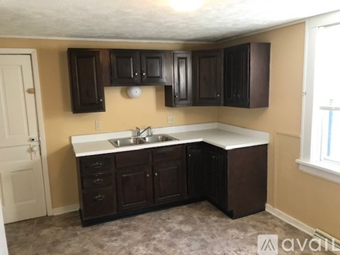 A kitchen with brown cabinets and a white countertop.