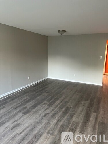 A room with grey flooring and a white ceiling.