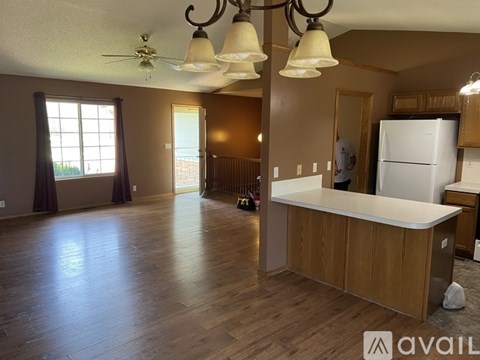 A kitchen with a white fridge and wooden cabinets.