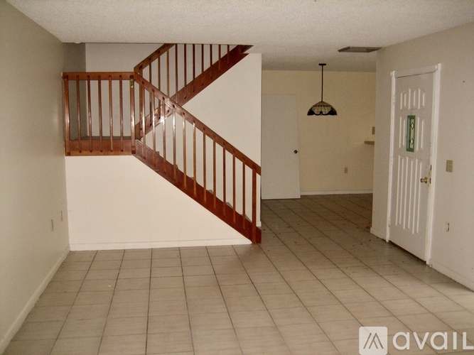 A room with a staircase and a door.