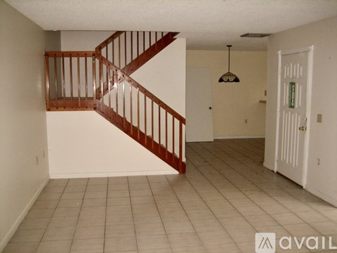 A room with a staircase and a door.