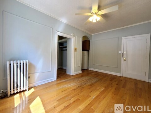A room with wooden floors and a ceiling fan.