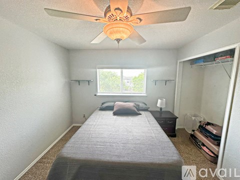 A bedroom with a bed, dresser, and window.