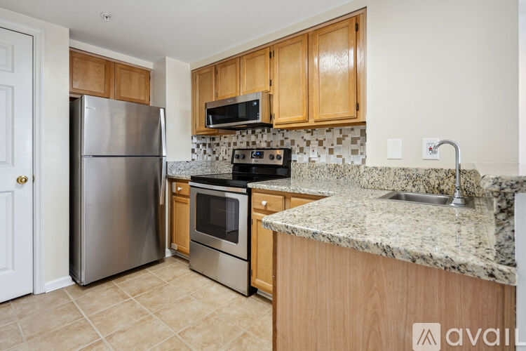 A kitchen with wooden cabinets and granite countertops.
