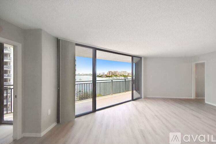A spacious room with a view of the outside through large windows.