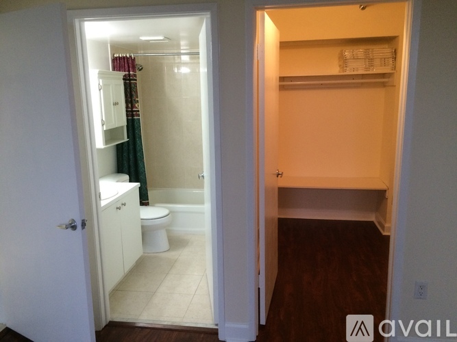 A bathroom with a toilet, sink, and shower.