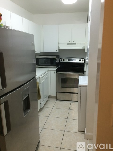 A kitchen with a stainless steel refrigerator and oven.