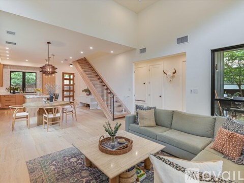 A living room with a grey couch and a wooden coffee table.