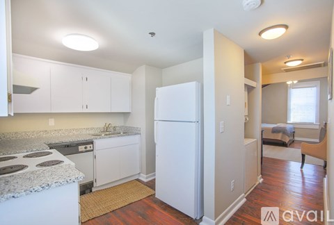 A kitchen with white appliances and cabinets.