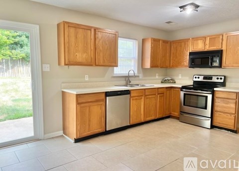 A kitchen with wooden cabinets and stainless steel appliances.