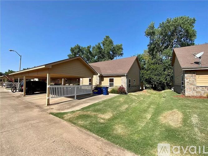 A house with a driveway and a garage is available for rent.