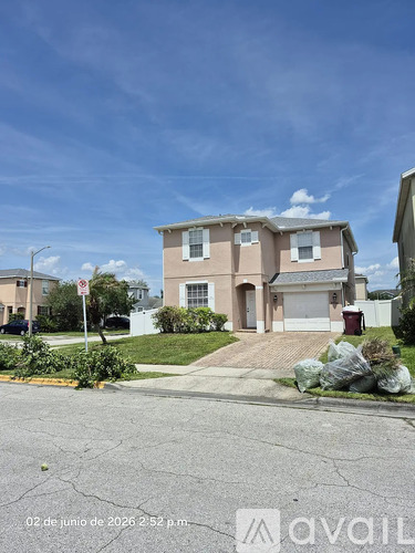 A house with a driveway and a no parking sign in front.