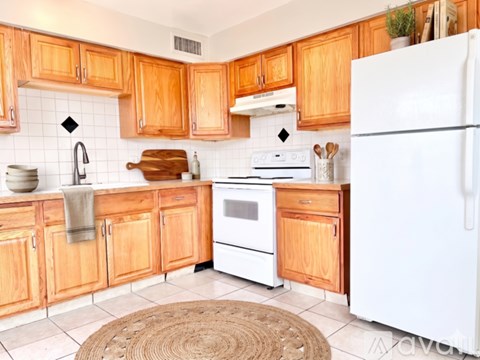A kitchen with wooden cabinets and white appliances.