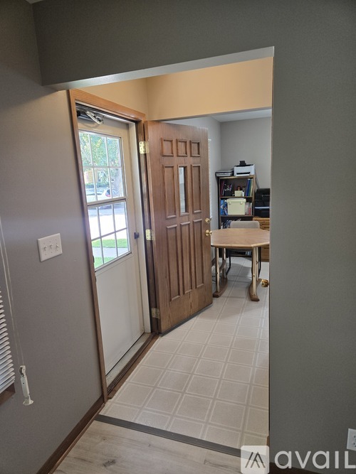 A room with a door and a table in it.