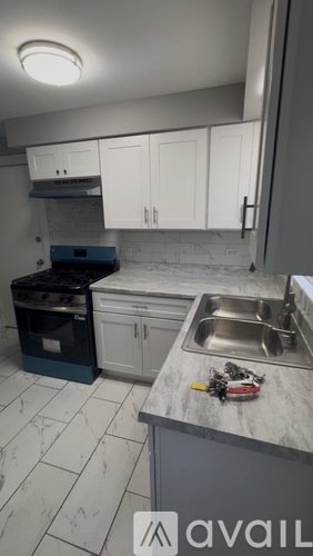 A kitchen with a sink, oven, and cabinets.