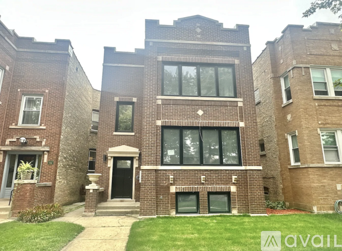 A brick building with a black door and windows.