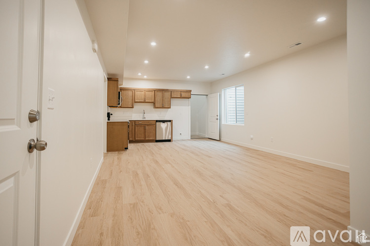 A room with wooden flooring and a white door.