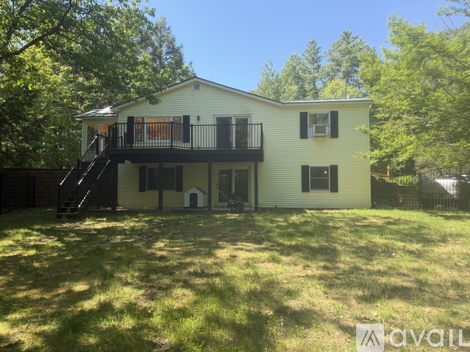 A two-story house with a balcony and a deck.