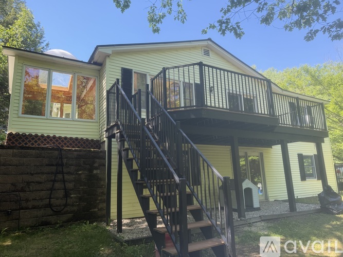 A house with a balcony and stairs leading to it.