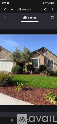 A house with a brown roof and a white garage door.