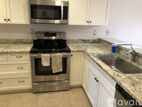 A kitchen with a stove top oven and a microwave above it.