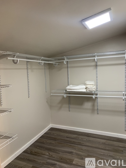 A room with a shelving unit and towels on it.
