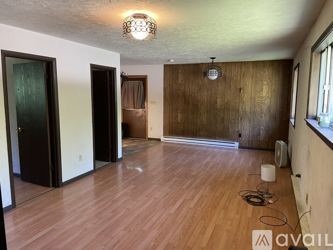 A room with wooden floors and a ceiling light.
