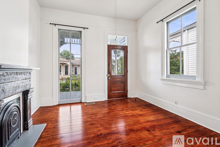 A room with a fireplace and hardwood floors.