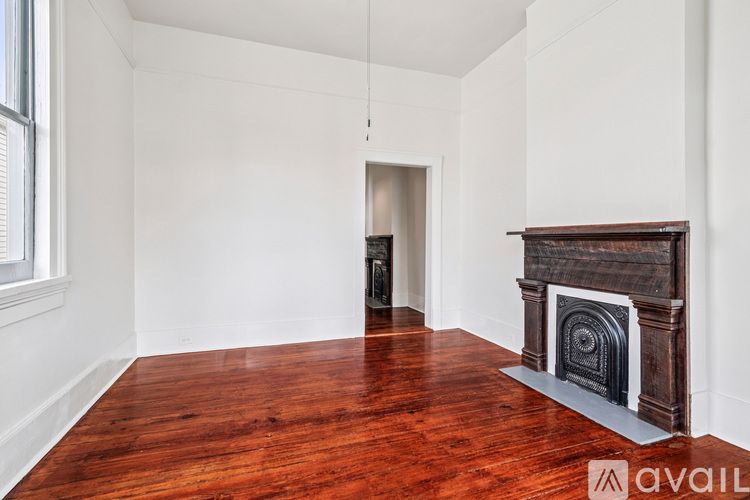 A room with a fireplace and wooden floors.