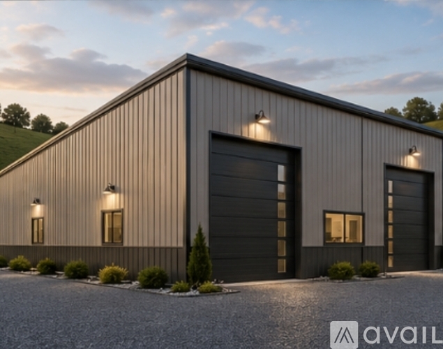 A modern building with a grey exterior and three garage doors.