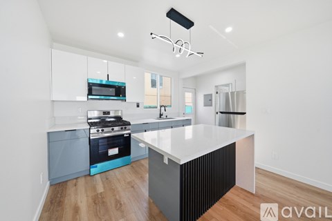 A modern kitchen with a white countertop and a black stove.