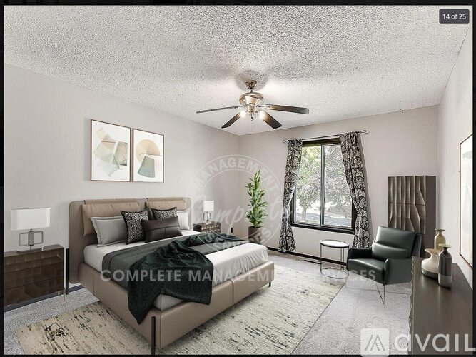 A bedroom with a large bed and a ceiling fan.