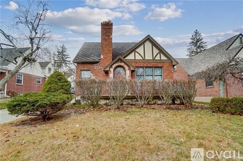 A house with a chimney and a large front yard.