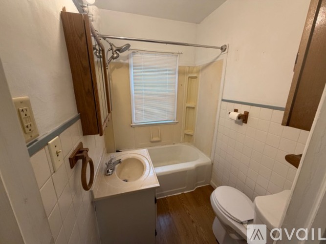 A bathroom with a toilet, sink, and bathtub.