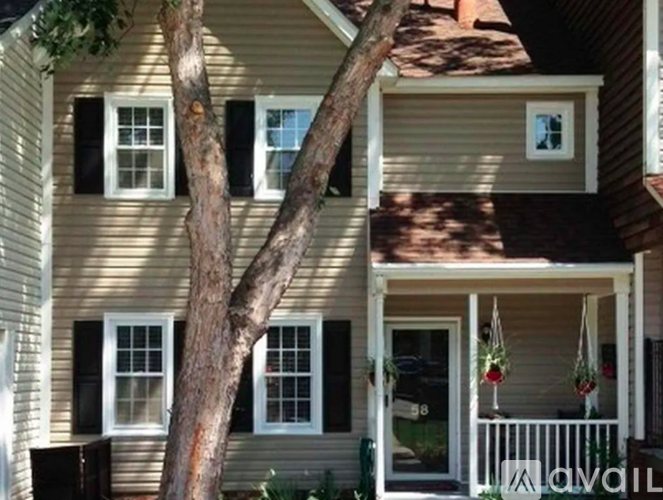 A house with a tree in front of it.