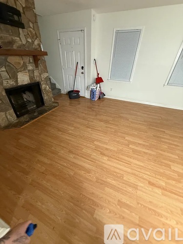 A room with a fireplace and a broom.