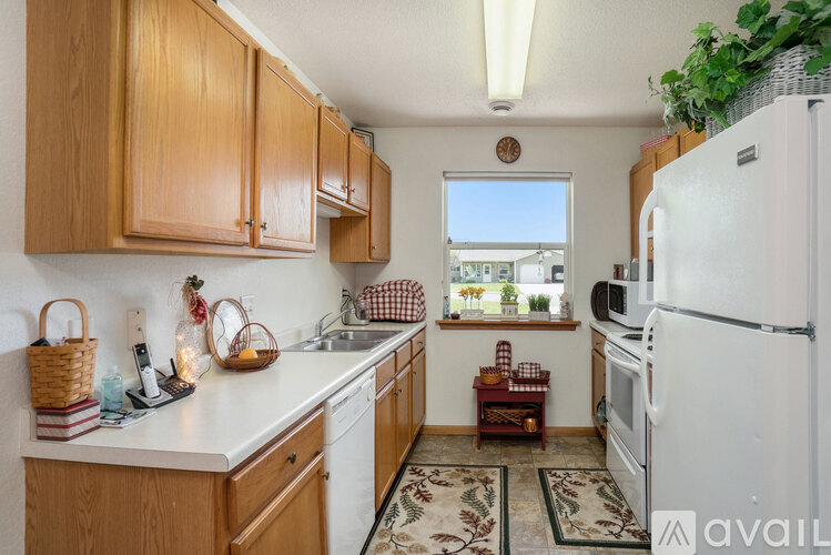 A kitchen with wooden cabinets and a white fridge.