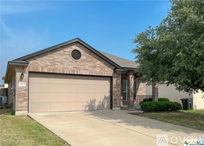 A house with a garage door and a window on the side.