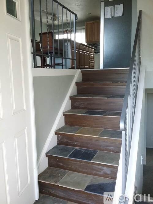 A staircase with a white door on the left side.