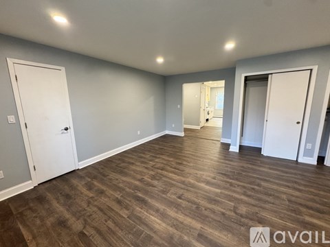 A room with wooden flooring and white doors.