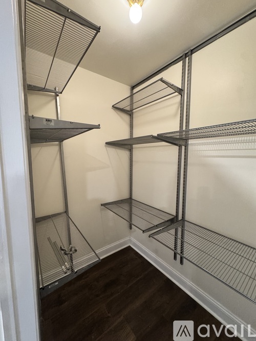 A room with a white wall and a shelving unit.
