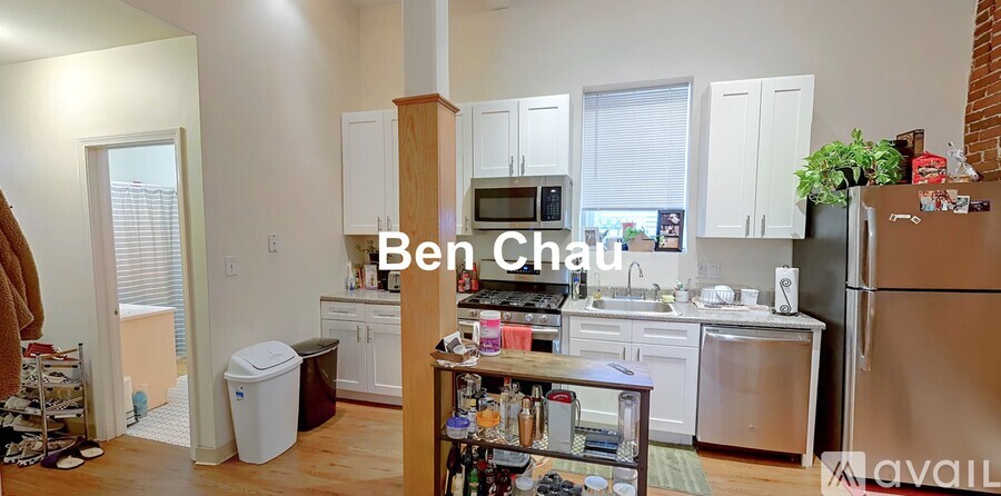 A kitchen with a refrigerator, cabinets, and a microwave.